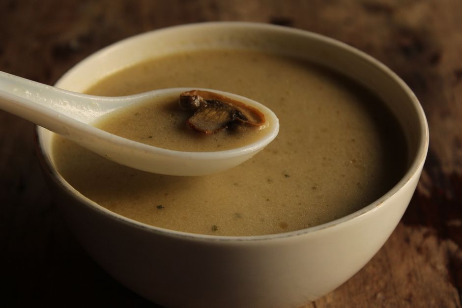 Warm and inviting creamy mushroom soup served in a ceramic bowl with spoon.