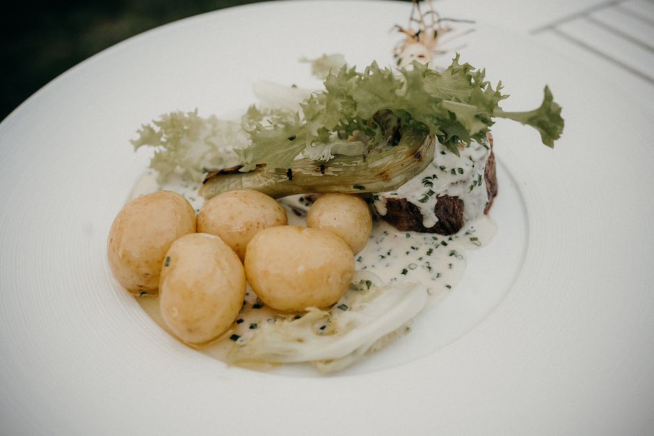Small boiled new potatoes with herbs on a plate